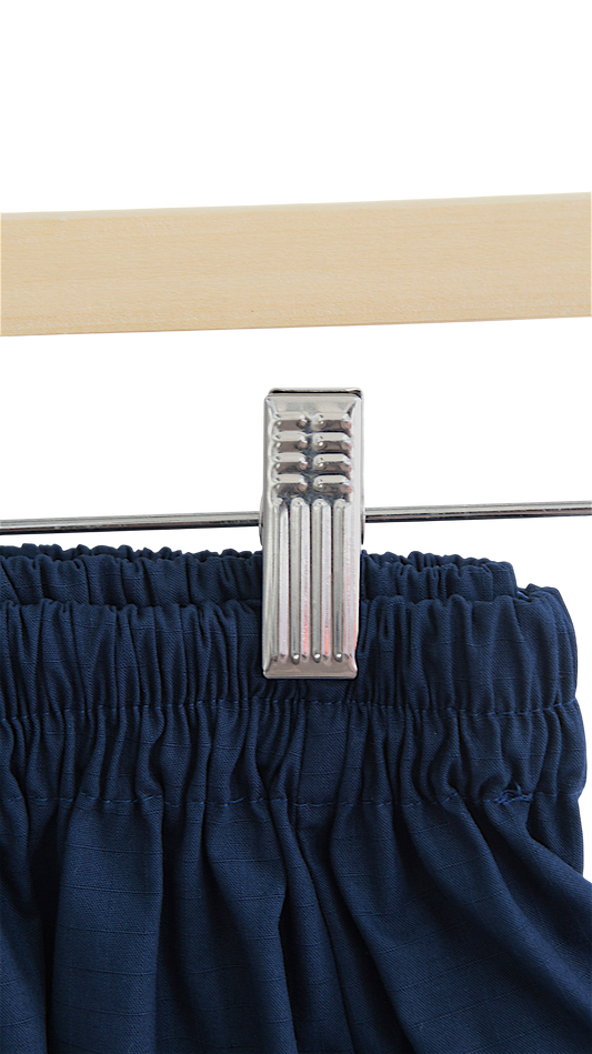 Lefke Legacy midnight indigo cotton shalwar with a gathered drawstring waist hanging on a wooden hanger.