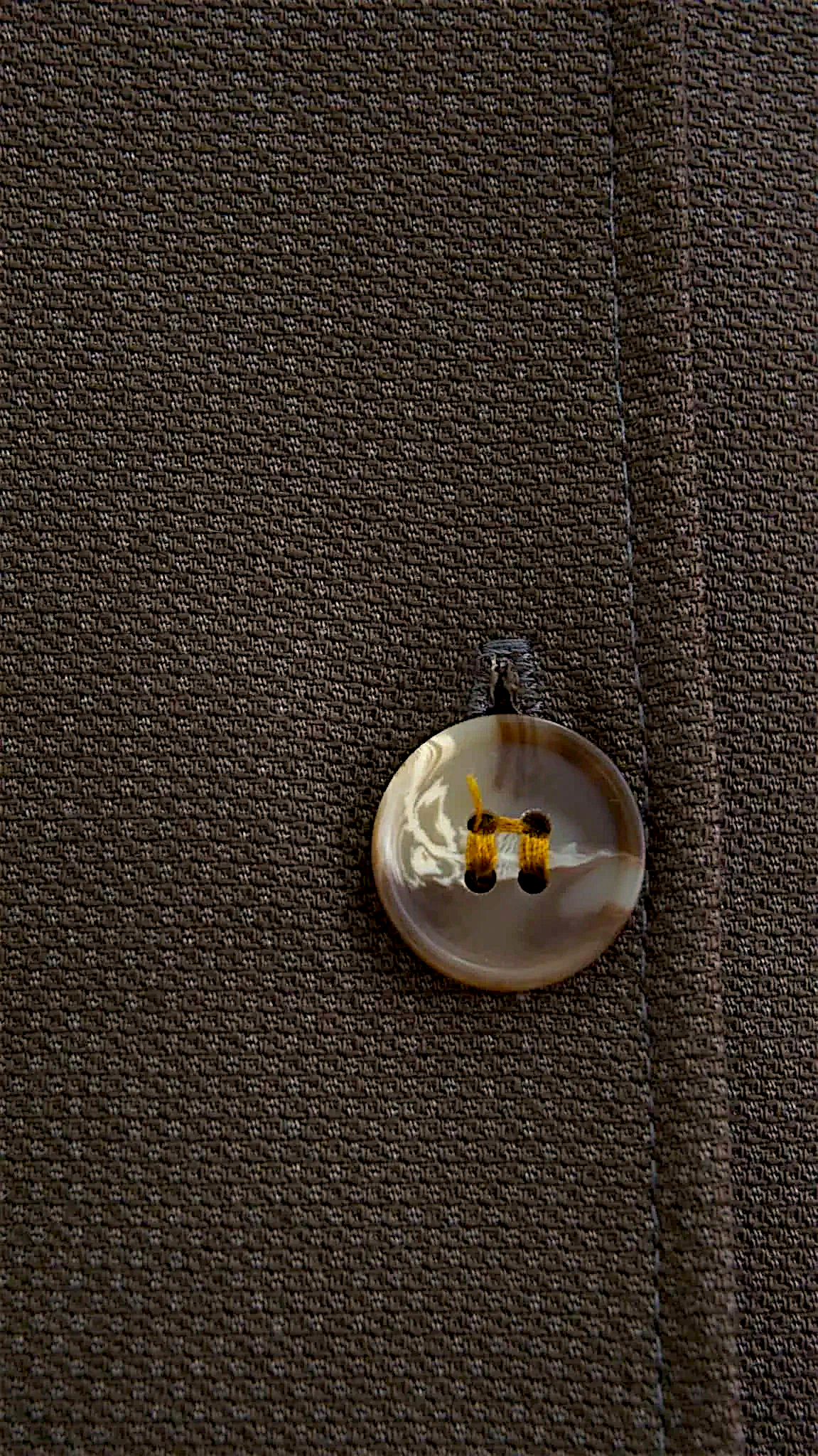 Lefke Legacy chocolate brown wool mix waistcoat featuring a detailed close-up of a button with contrast stitching.
